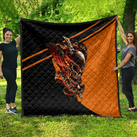 Large black and orange quilt with skull-with-wings print and diagonal orange stripe