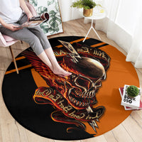 Round black area rug with large orange flaming skull artwork and lightning bolt motif.