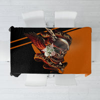Black tablecloth with orange winged skull graphic, draped over table corners