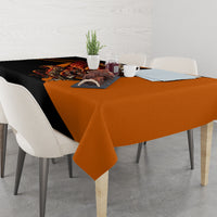 Orange and black skull tablecloth on dining table with hanging edges