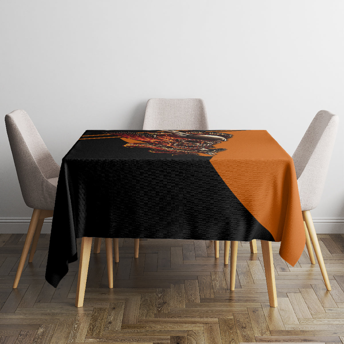 Square black and orange skull tablecloth on table with four fabric chairs