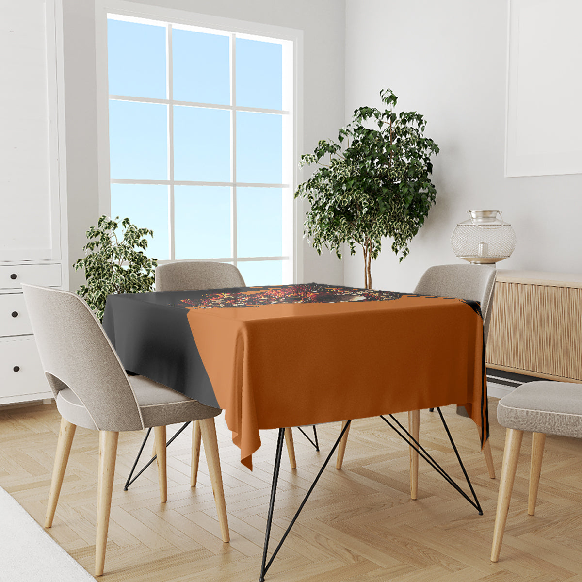 Black and orange skull tablecloth on dining table with multiple chairs