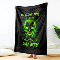 Black blanket draped with neon green skull graphic and distressed lettering
