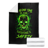 Black blanket with neon green flame skull graphic and text, folded with white rolls