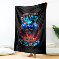 Black skull graphic blanket with PLAYer and coach text, hanging up