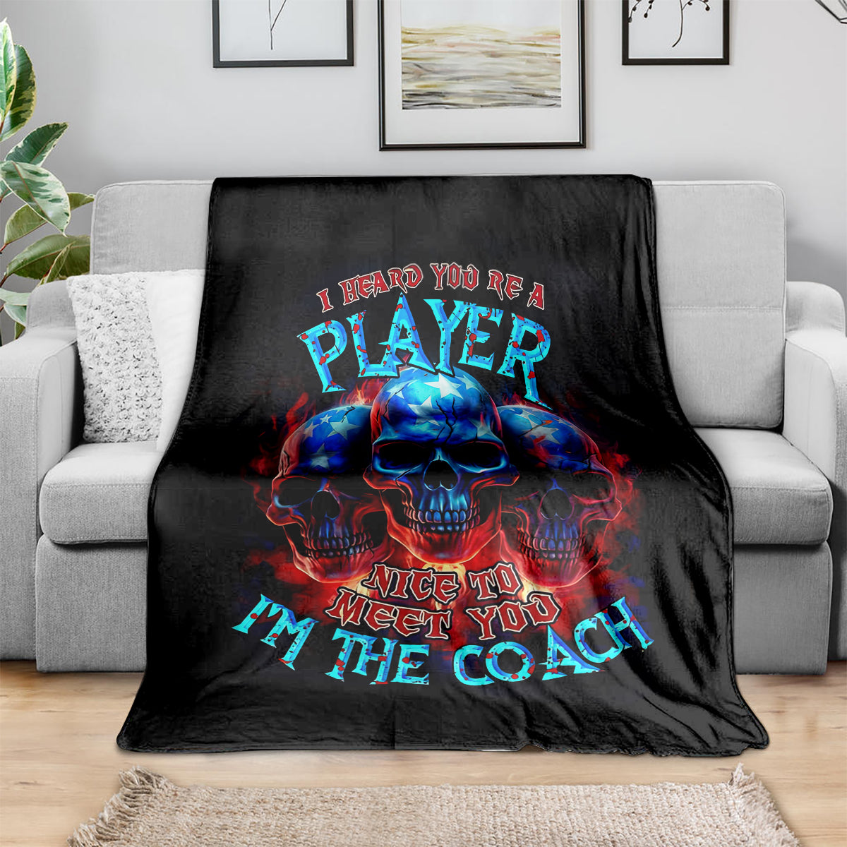Black skull graphic blanket with PLAYer and Nice to meet you text on sofa