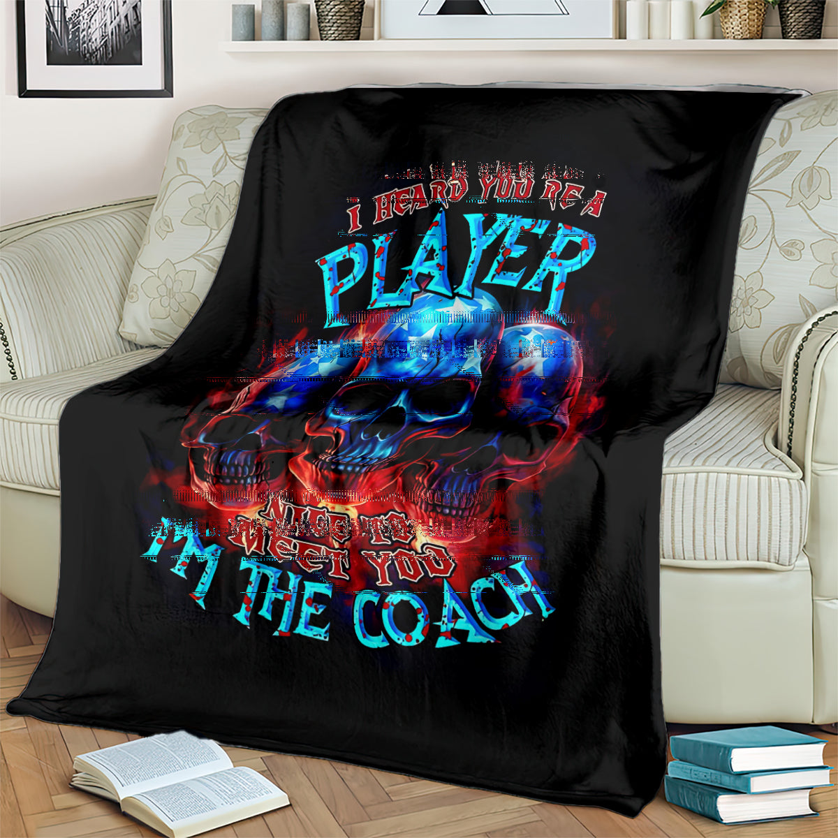 Black skull graphic blanket with PLAYer and Nice to meet you text on couch