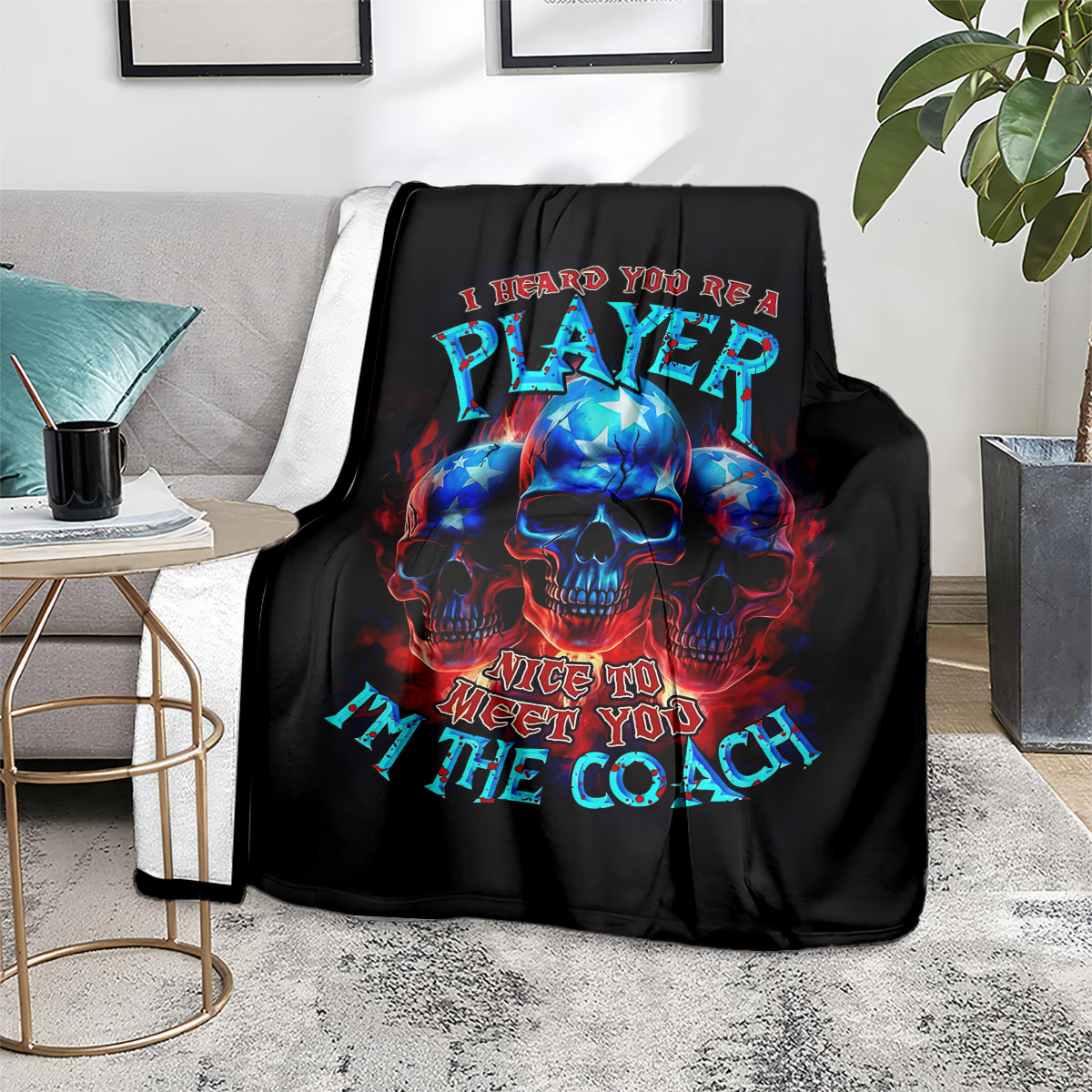 Black skull graphic blanket on sofa, colorful PLAYer and Nice to meet you text