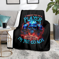 Black skull graphic blanket on sofa, colorful PLAYer and Nice to meet you text