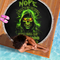 Black circular beach blanket with green skull graphic and white fringe