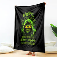 Black skull graphic blanket, neon green glowing face and arched dark text on fabric