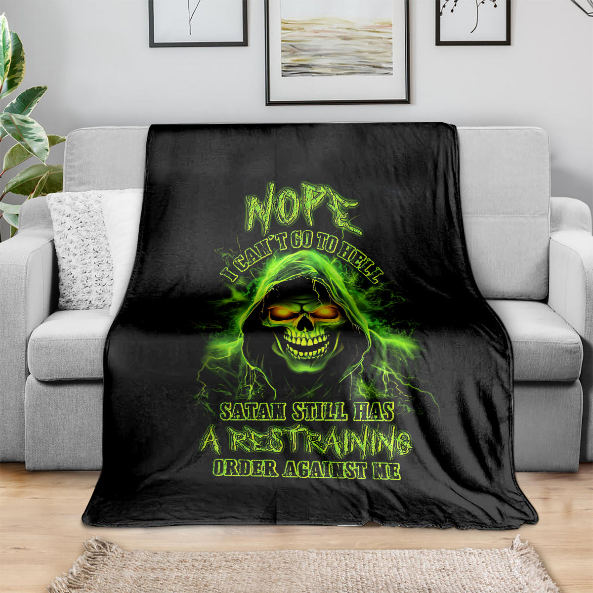 Black skull graphic blanket with neon green glowing face and dark text design