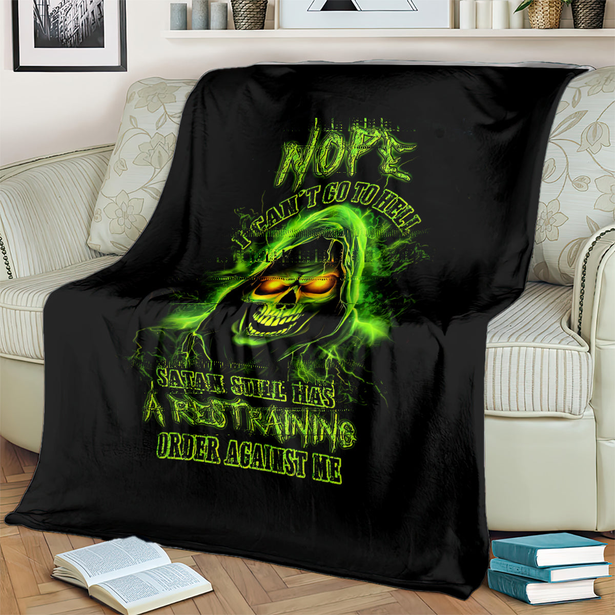 Black skull graphic blanket draped on sofa, neon green glowing skull face with text