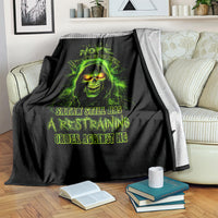 Black skull graphic blanket partially folded on couch, neon green glowing face and text