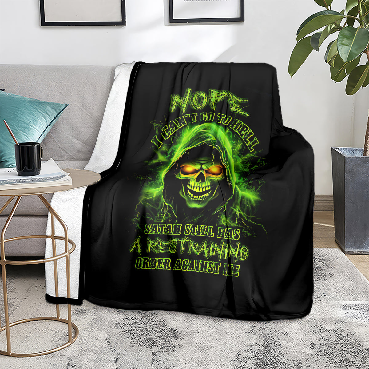 Black skull graphic blanket on chair, neon green glowing skull face with warning text