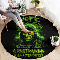 Black round rug with neon green skull face graphic and flame accents, text band