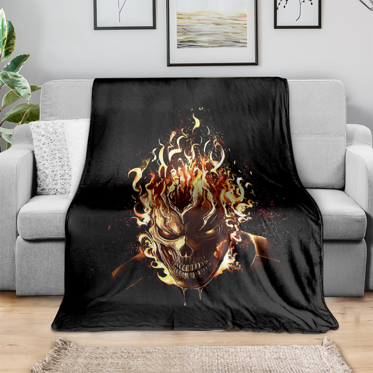 Black flame skull throw blanket with blazing skull graphic, spread across sofa