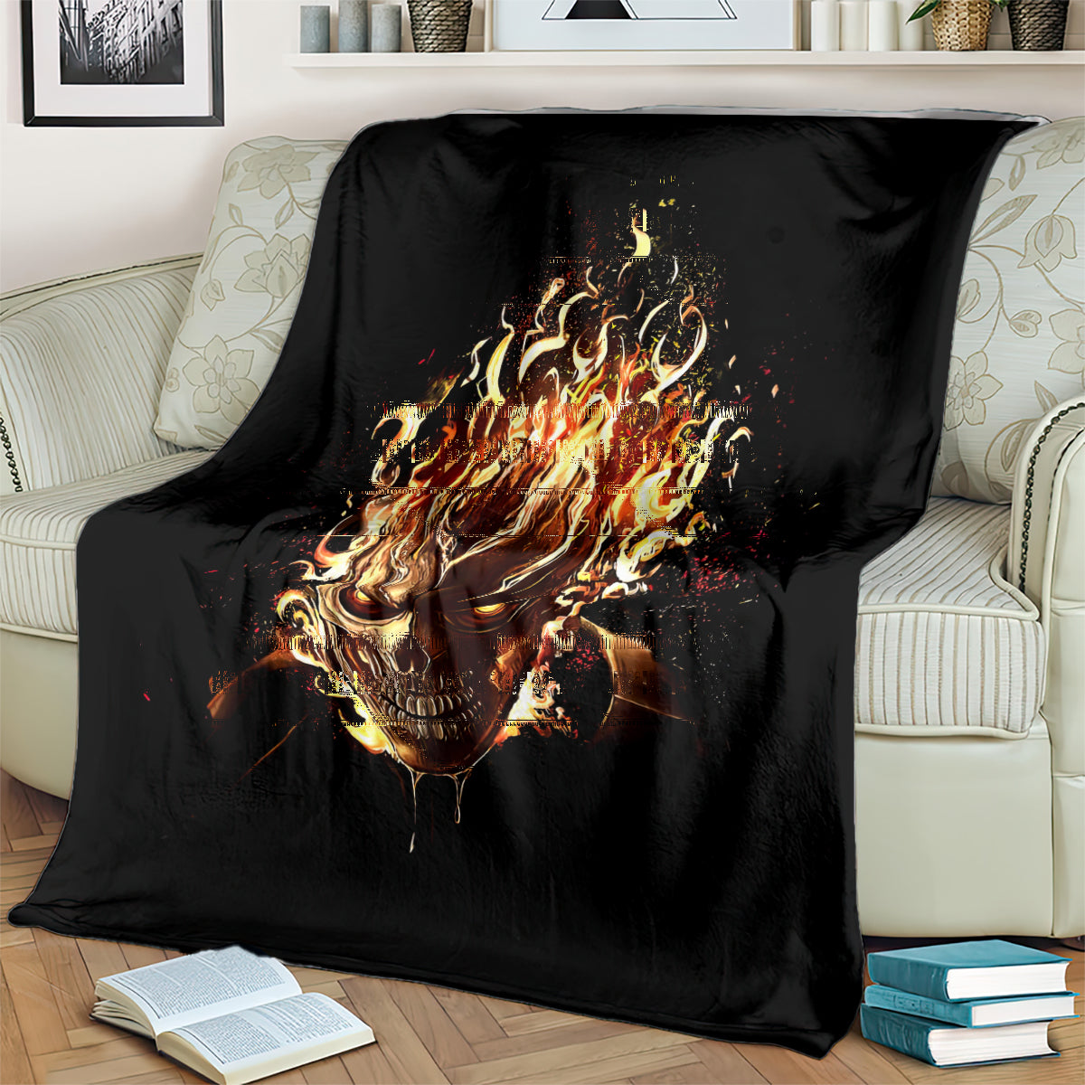 Black flame skull blanket with burning skull graphic, laid over couch back