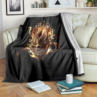 Black flame skull blanket with fiery skull graphic, draped over sofa arm