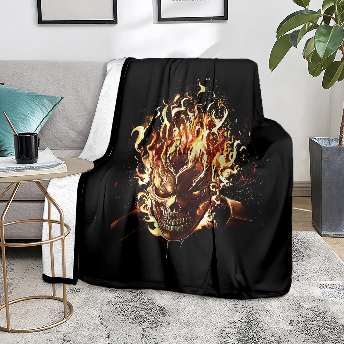 Black flame skull blanket with fiery skull graphic, folded over sofa seat