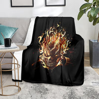 Black flame skull blanket with fiery skull graphic, folded over sofa seat