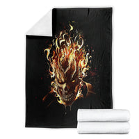Black flame skull blanket with blazing skull graphic, folded with rolled fabric