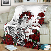 White skull and red rose skeleton blanket spread across bed