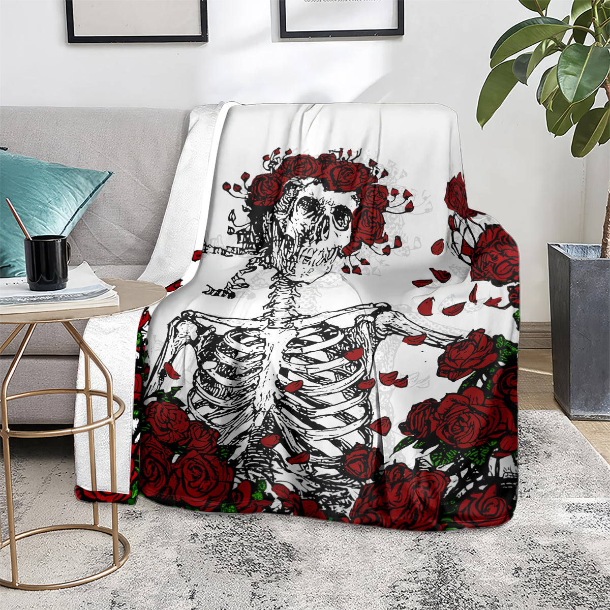 White blanket featuring red rose skull and skeleton ribcage artwork, folded drape