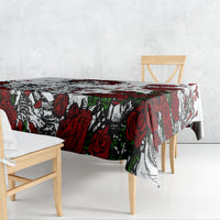 Skull and rose print tablecloth in red, black, and white, draped on table