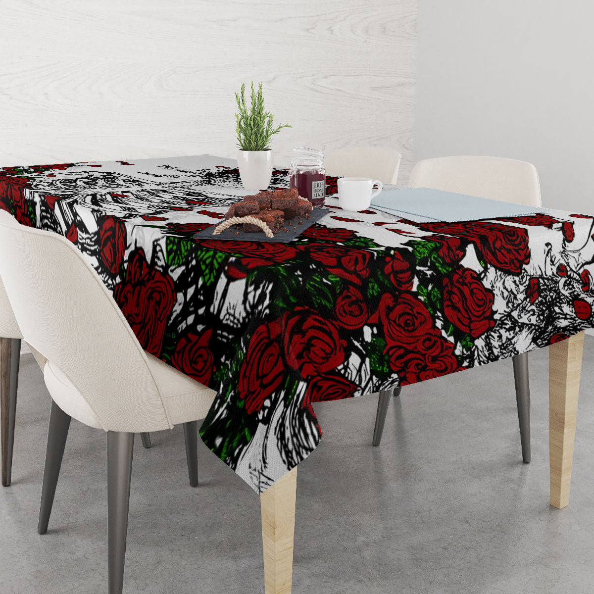 Skull and rose tablecloth with overhanging corners, red and black print on white