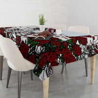 Skull and rose tablecloth with overhanging corners, red and black print on white