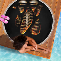 Round black beach blanket with white fringe; fiery skull skeleton front design