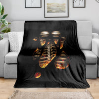 Black flame skull skeleton inside body blanket draped on a sofa