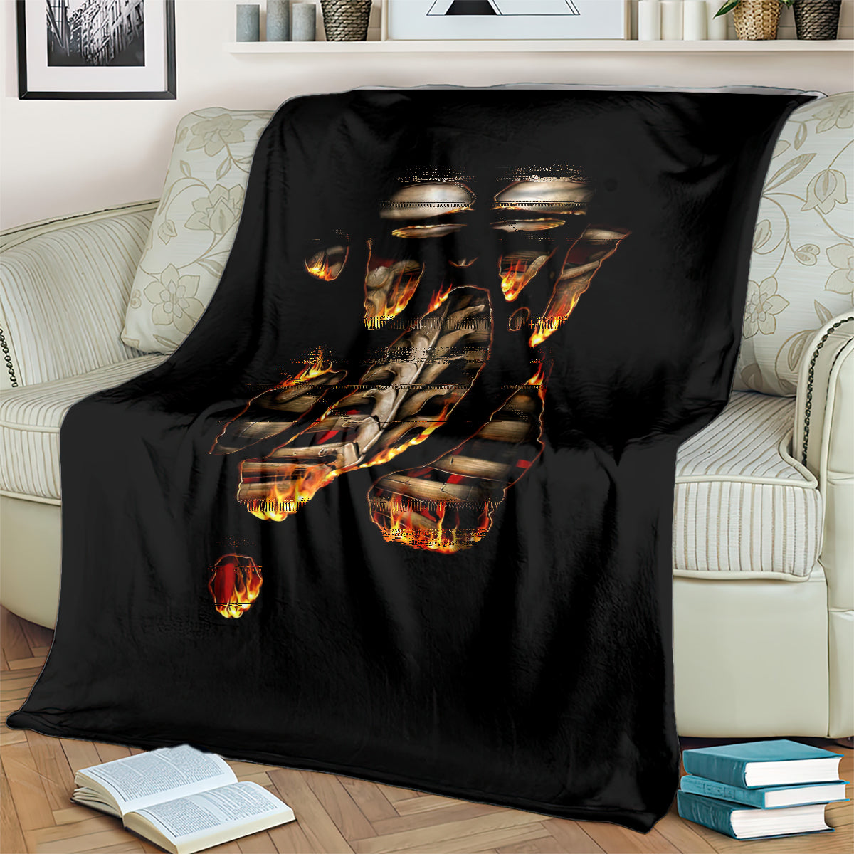 Black flame skull skeleton inside body blanket spread over a couch