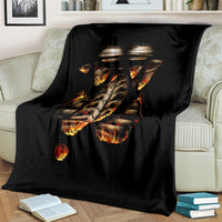 Black flame skull skeleton inside body blanket spread over a couch