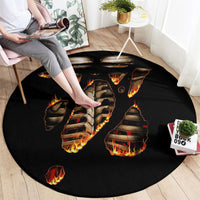 Black round rug with centered flaming skull skeleton ribcage graphic and ember flames