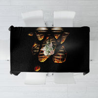 Black tablecloth laid flat featuring flaming skull skeleton design in orange and yellow