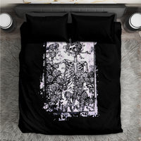 Black bedding set with white skull and skeleton rose graphic, two black pillowcases