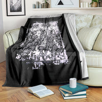 Black skull and rose blanket over a chair back, white printed skeleton illustration