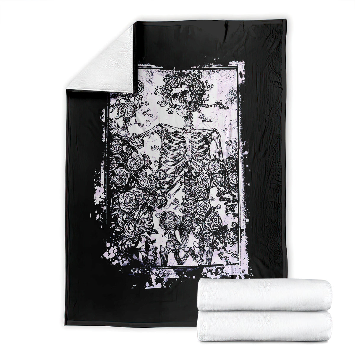 Black skull and rose graphic blanket with white framed print, folded with stacks