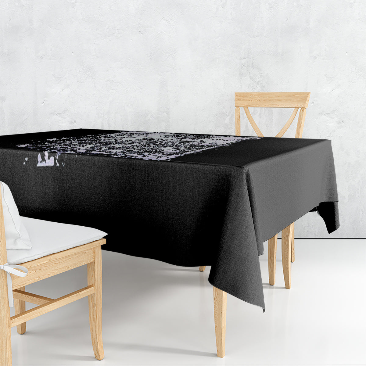 Black tablecloth with white abstract skull and rose print, draped over table