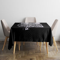 Black tablecloth with centered white skull and rose graphic on dining table