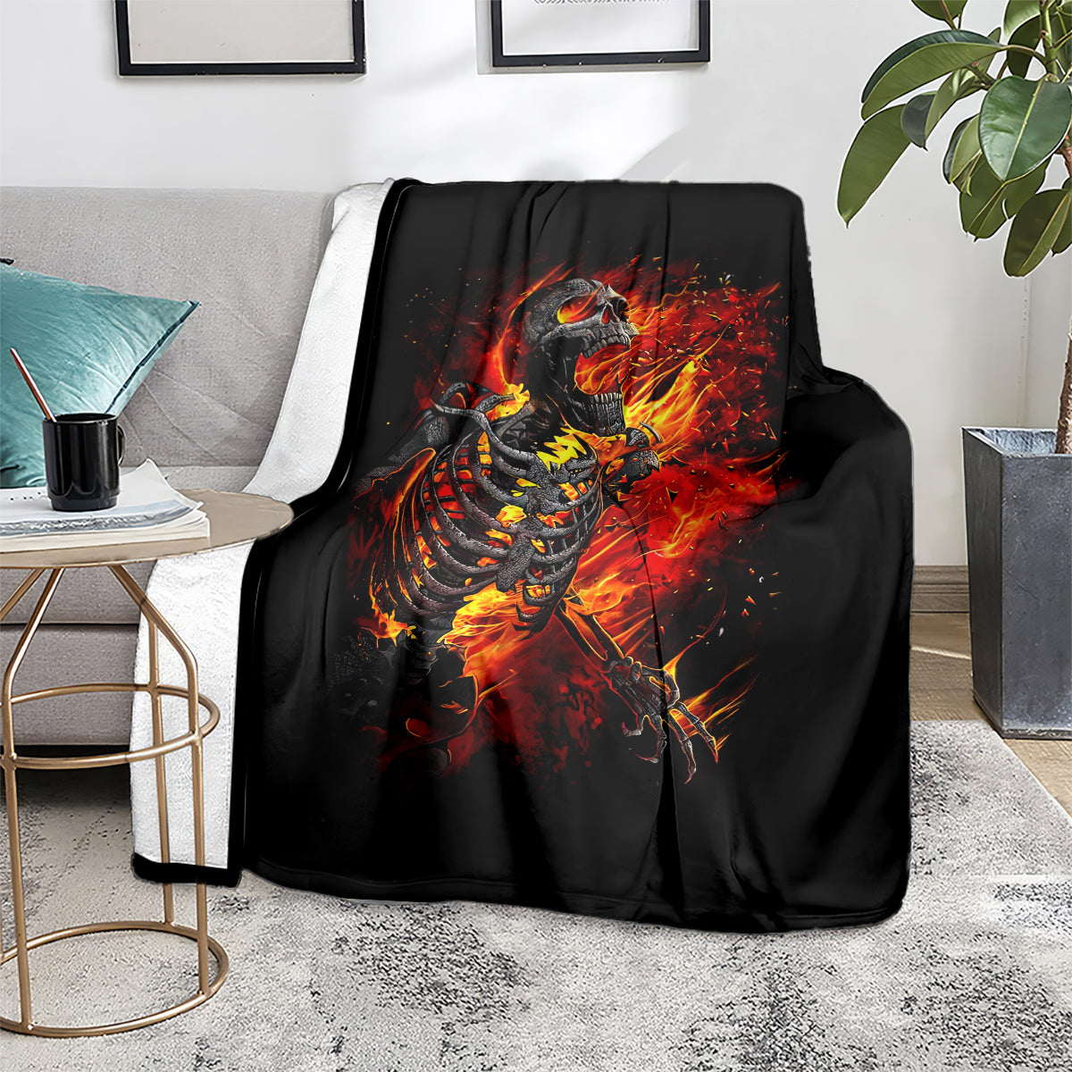 Black fire skull skeleton blanket on gray couch with fiery flame artwork