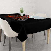 Black tablecloth draped over dining table with fiery skull skeleton artwork