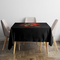 Black tablecloth on square table featuring fiery skull skeleton design in red and orange