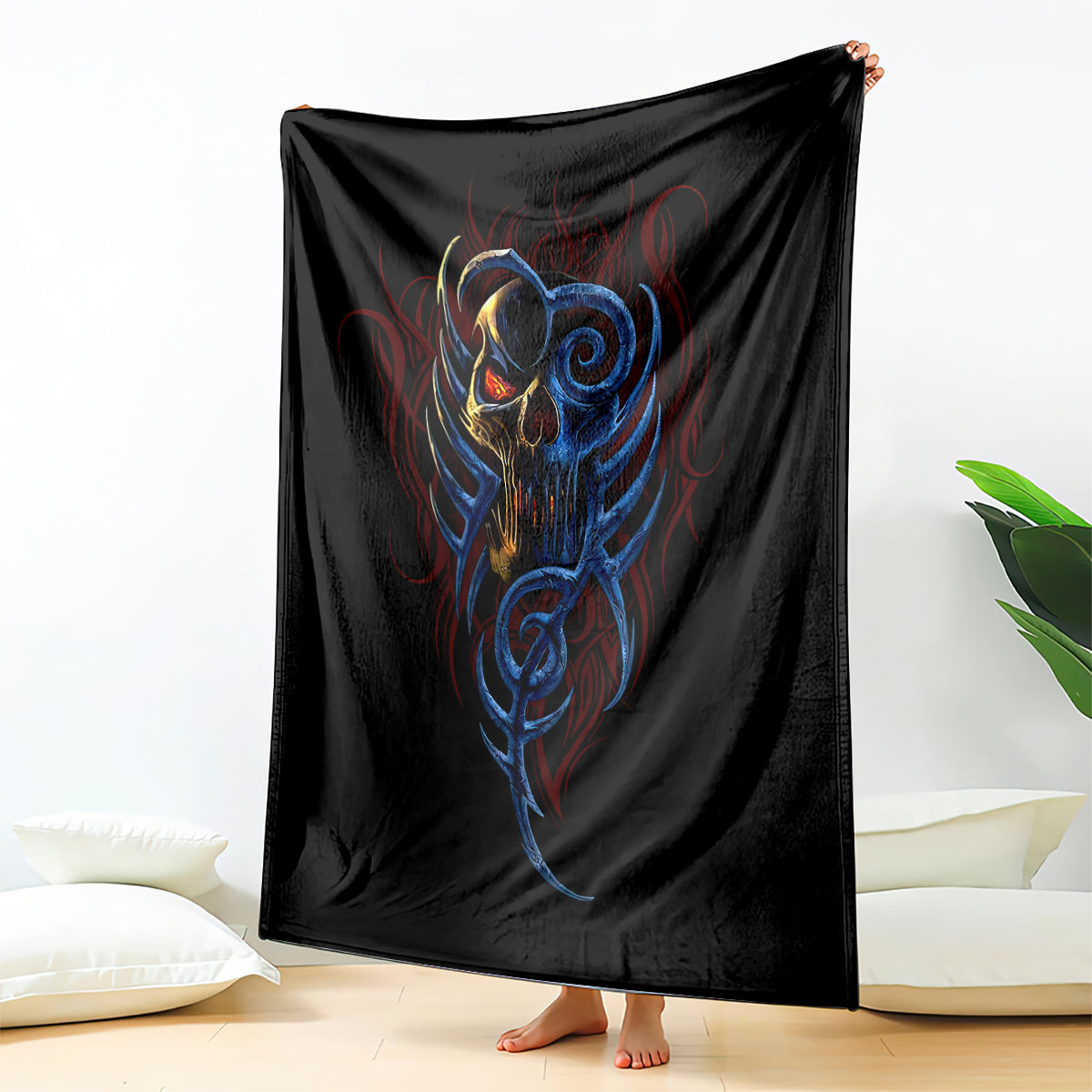 Black blanket with blue-and-gold devil skull graphic, draped with corners visible