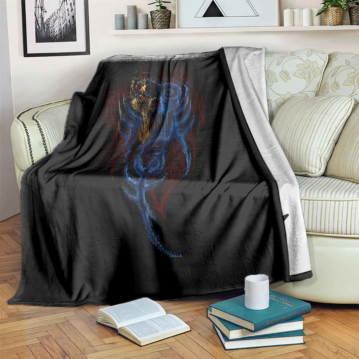Black devil skull blanket with blue and red flame-like details, draped over couch