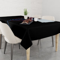 Black tablecloth on dining table with blue devil graphic and hanging corner
