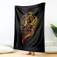 Black tattoo skull blanket with golden face graphic, draped over bed