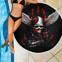 Black round beach blanket with winged skull, red roses, and a white fringed edge.